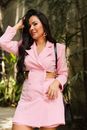 Woman in Pink Blazer Standing Near Green Plants