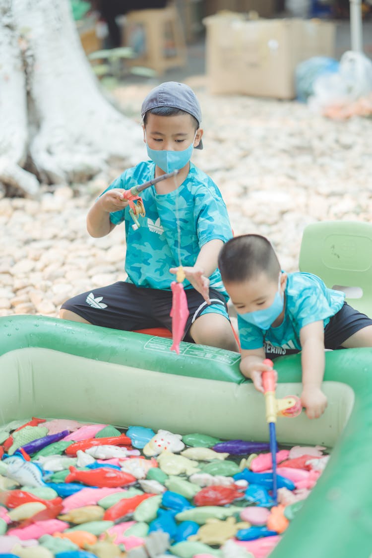 Kids Playing The Floating Toys On The Inflatable Pool