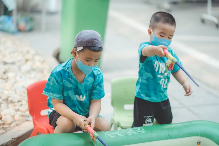 Boys In Masks Playing With Toys