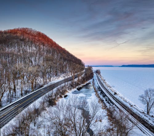 Aerial View of a Road Along a Frozen Shore 