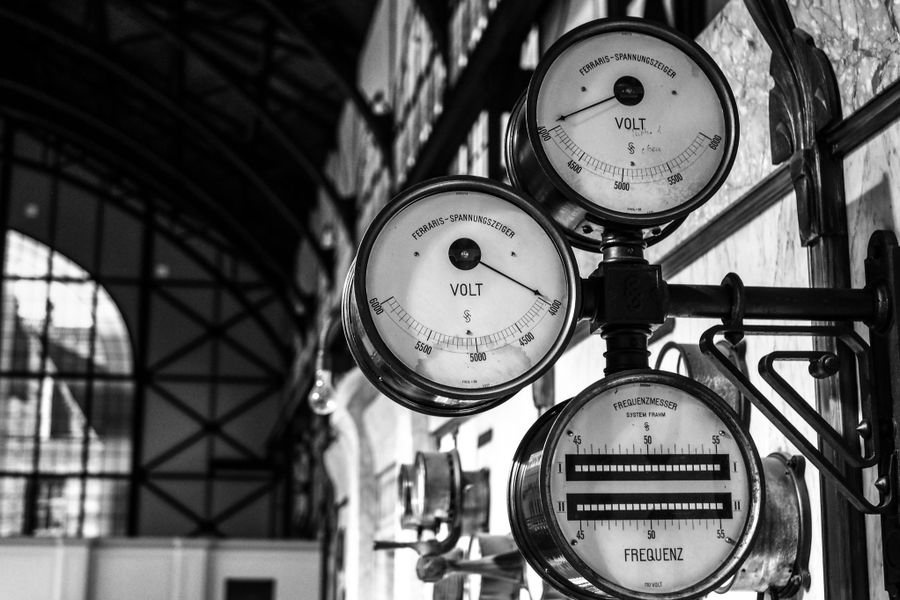 Black and white image of antique voltage gauges in a historic Dortmund building.