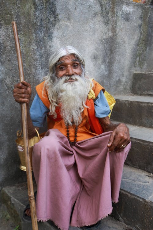 Old Bearded Man Sitting on Stairs