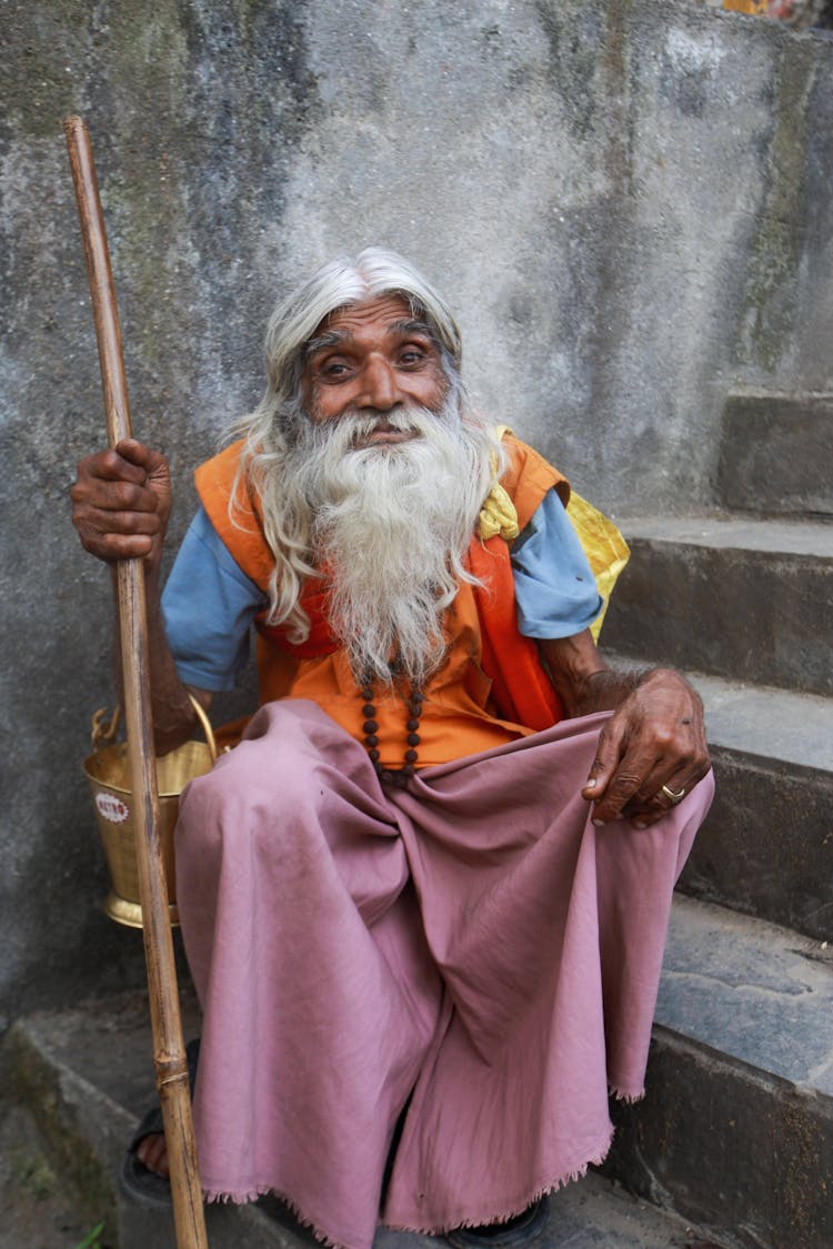 Old Bearded Man Sitting On Stairs