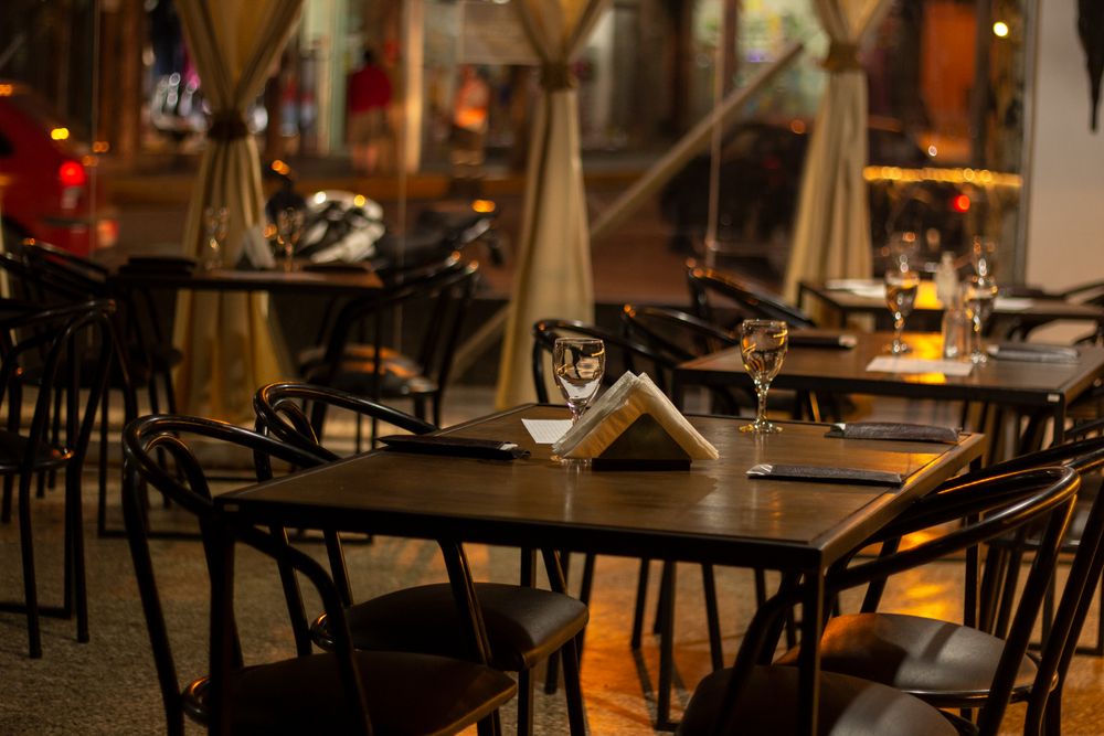 A warmly lit, quiet dining room set for the evening