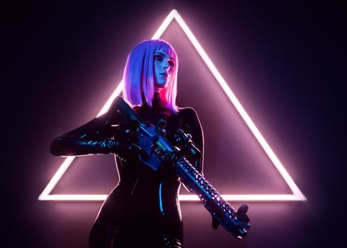 A Woman in Black Leather Outfit Holding a Modern Weapon