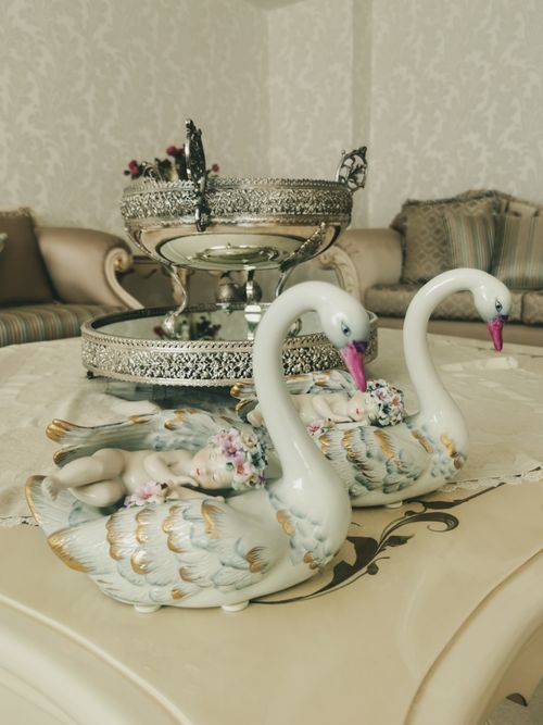 Free Vintage porcelain swans with intricate tableware in a luxurious setting, creating a retro aesthetic. Stock Photo