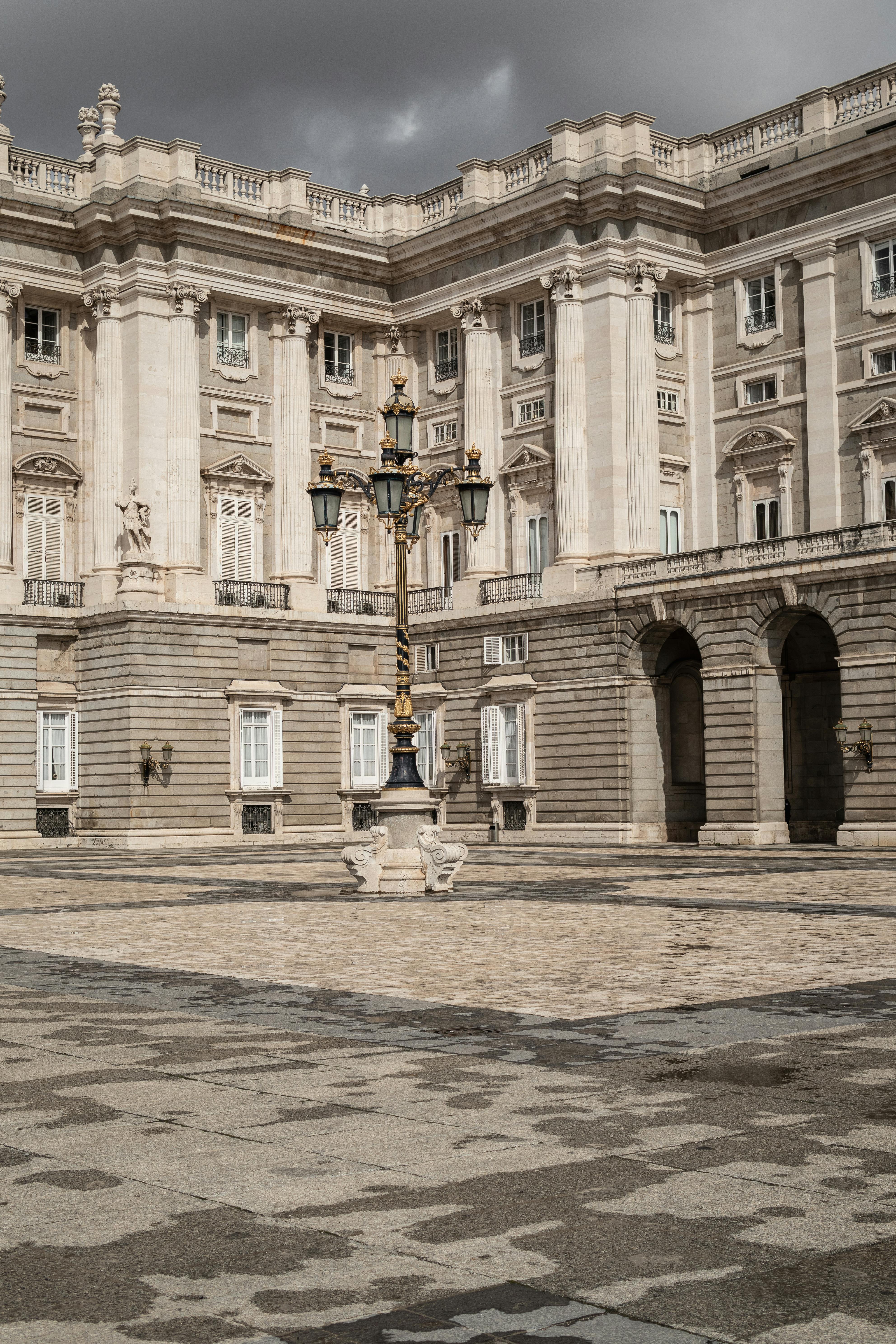 a corner of the royal palace of madrid with elegant street light in madrid spain