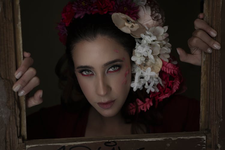 Woman Posing In Frame With Flowers In Hair