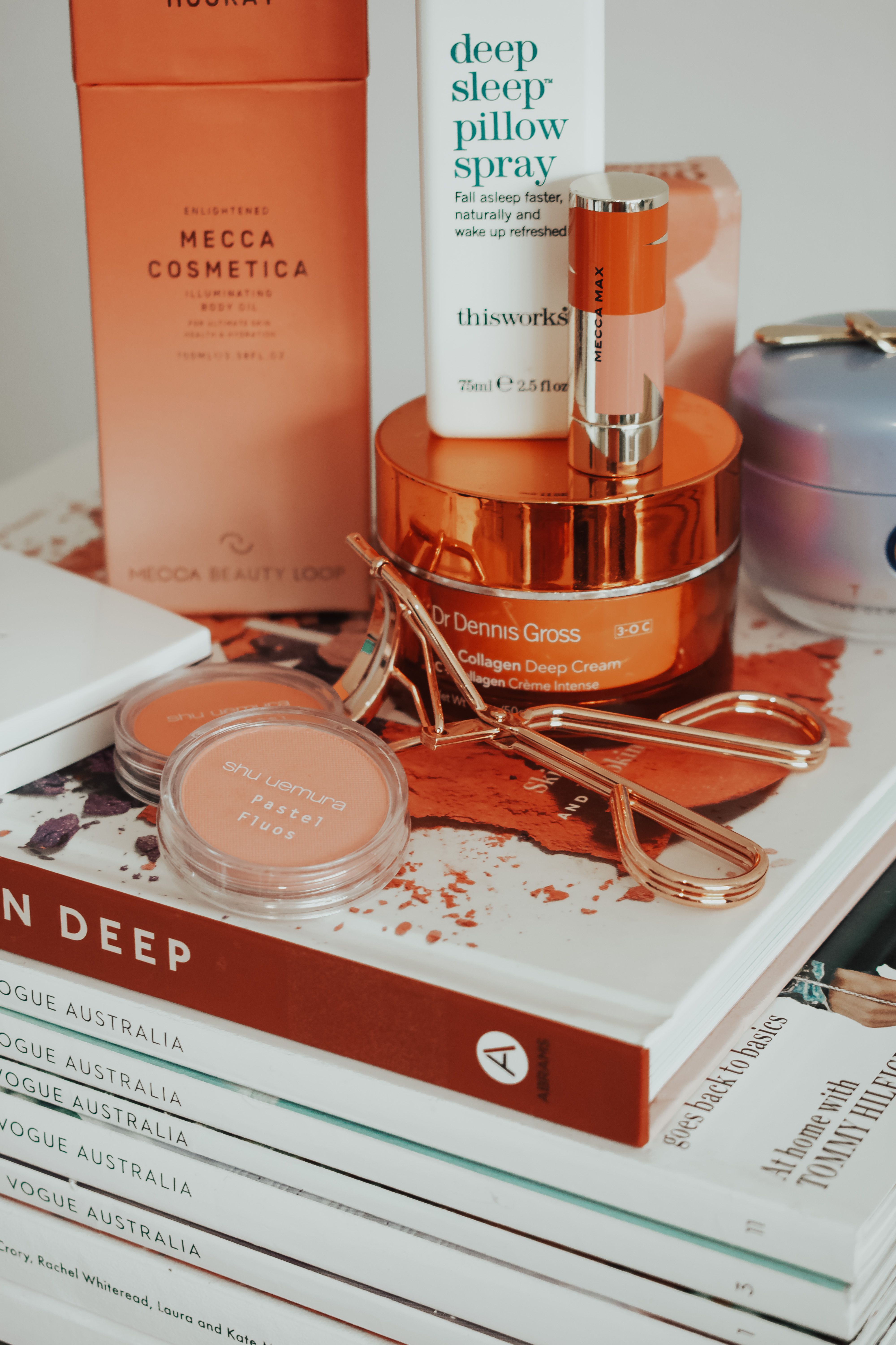Stylish arrangement of skincare and beauty products with books in Melbourne.