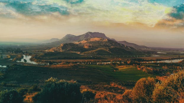Breathtaking landscape of Şehitkamil, Gaziantep featuring mountains, farmland, and a tranquil river.