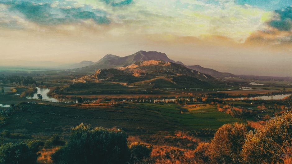 Fotomural Impresionante paisaje de Şehitkamil, Gaziantep, con montañas, tierras de cultivo y un río tranquilo.