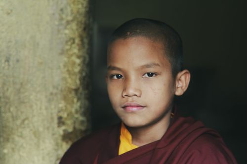 Free Close-up portrait of a young monk in traditional attire, exuding calmness and serenity. Stock Photo