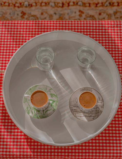 Free Glasses of Water and Cups of Coffee om White Tray Stock Photo