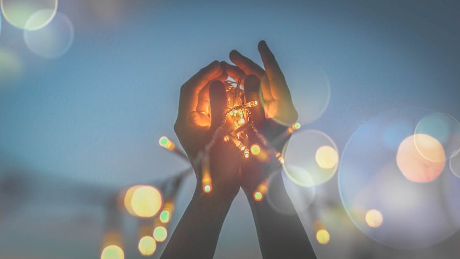 Person's Hand With Light Bokeh