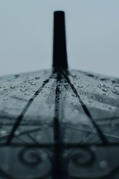 Detailed view of raindrops on a transparent umbrella, showcasing weather and texture.