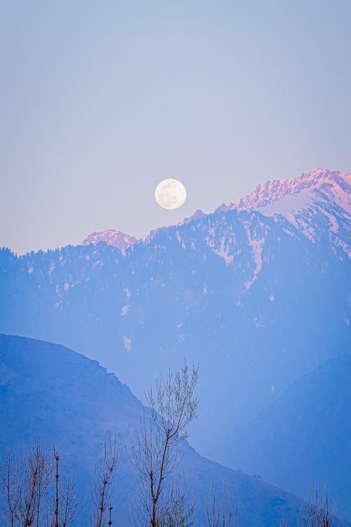 Moon Over the Snow Capped Mountains