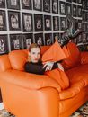 A Fashionable Woman in Black Long Sleeve Shirt and Orange Pants