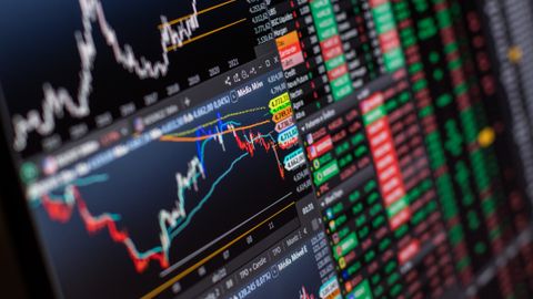 Detailed view of stock market charts and data on a monitor, showcasing market trends.