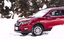 A Parked Red Nissan Rogue during Winter