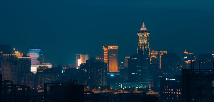 Captivating nighttime view of Hangzhou's illuminated cityscape featuring modern skyscrapers and vibrant lights.