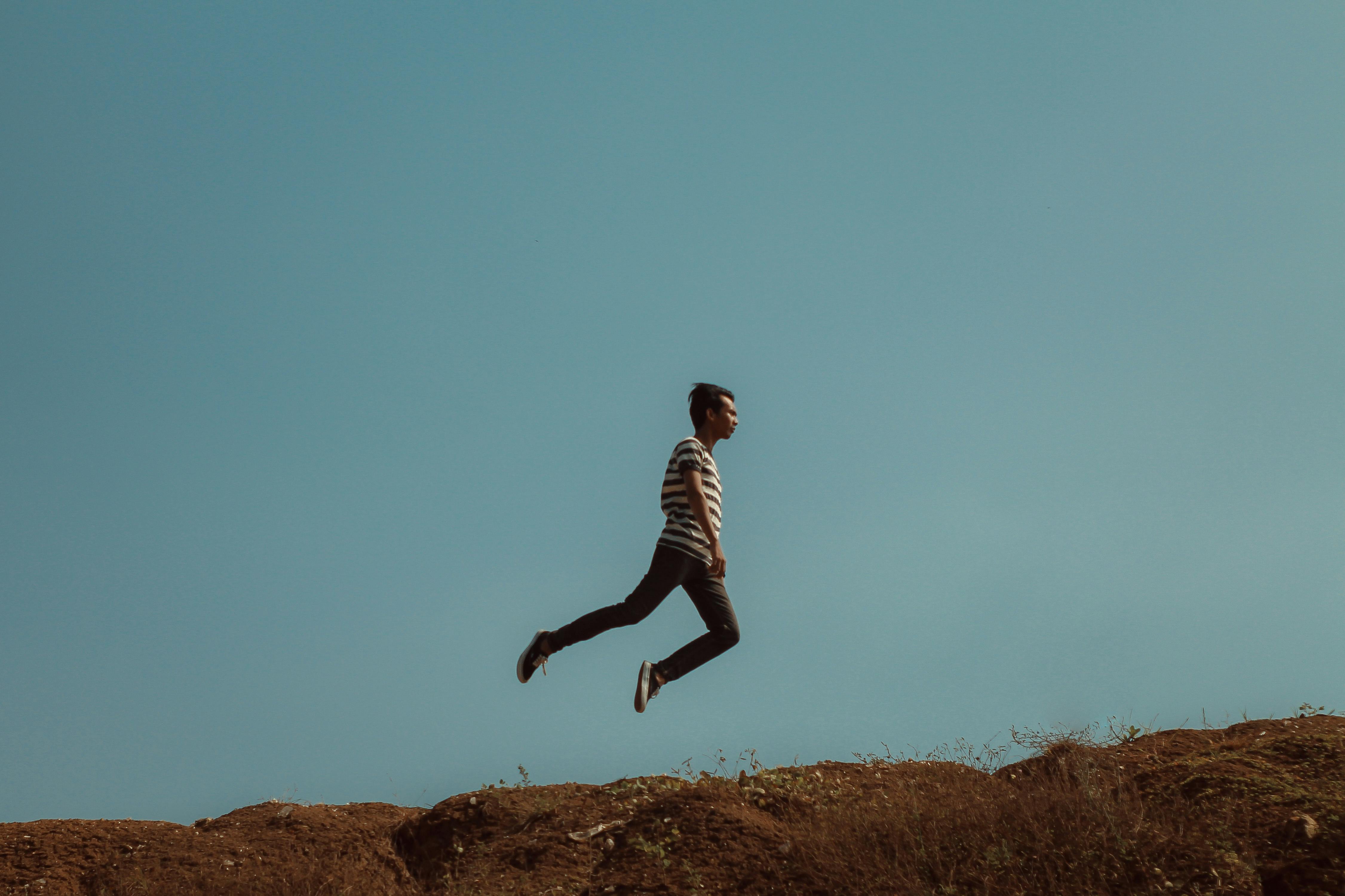Man Jumping Near the Cliff · Free Stock Photo