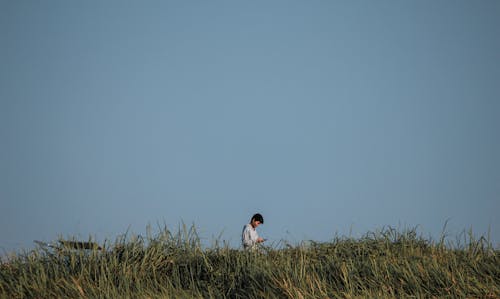 Man Standing On Green Grass