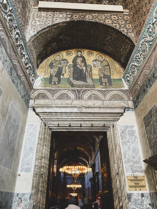 Free Historic entrance of Hagia Sophia Grand Mosque showcasing intricate mosaics and chandeliers. Stock Photo