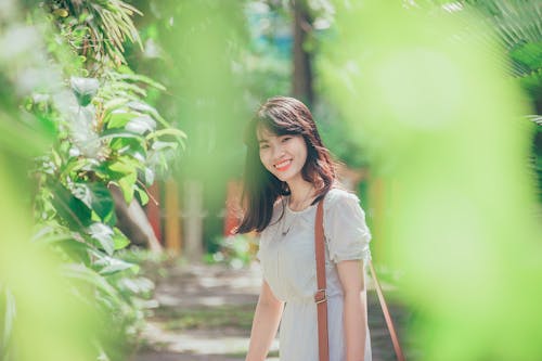 Free Woman Standing Nearby Green Leafed Plant Stock Photo