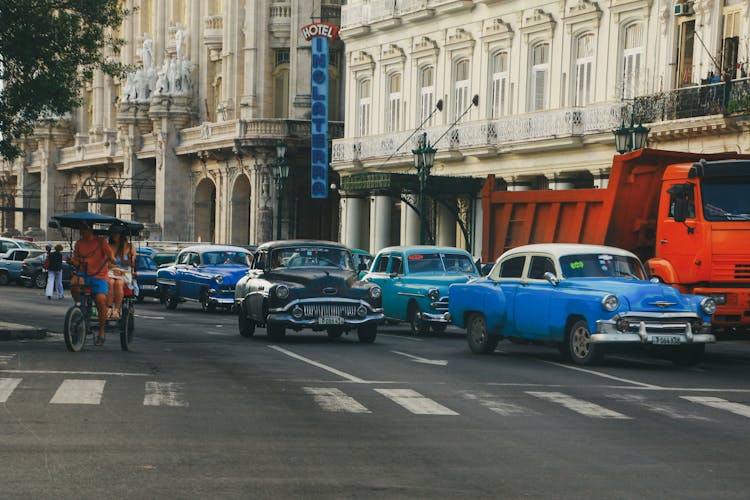 Retro Cars Driving On City Street