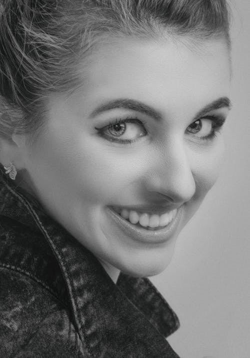 Grayscale Photo of a Woman Smiling