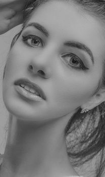 Artistic grayscale portrait of a woman with elegant features and expressive eyes.