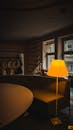 A Yellow Lampshade Beside a Table and Sofa
