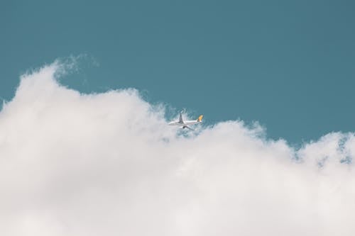 A White  Airplane Flying in the Sky