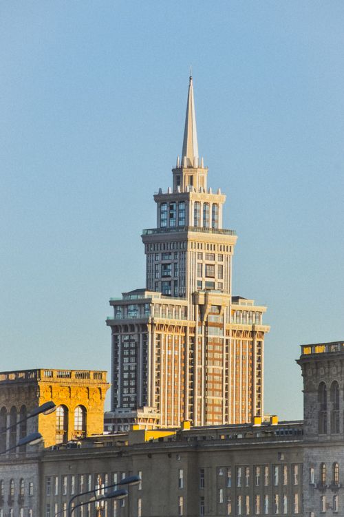 Free A close-up view of a towering skyscraper with a prominent spire against a clear sky. Stock Photo