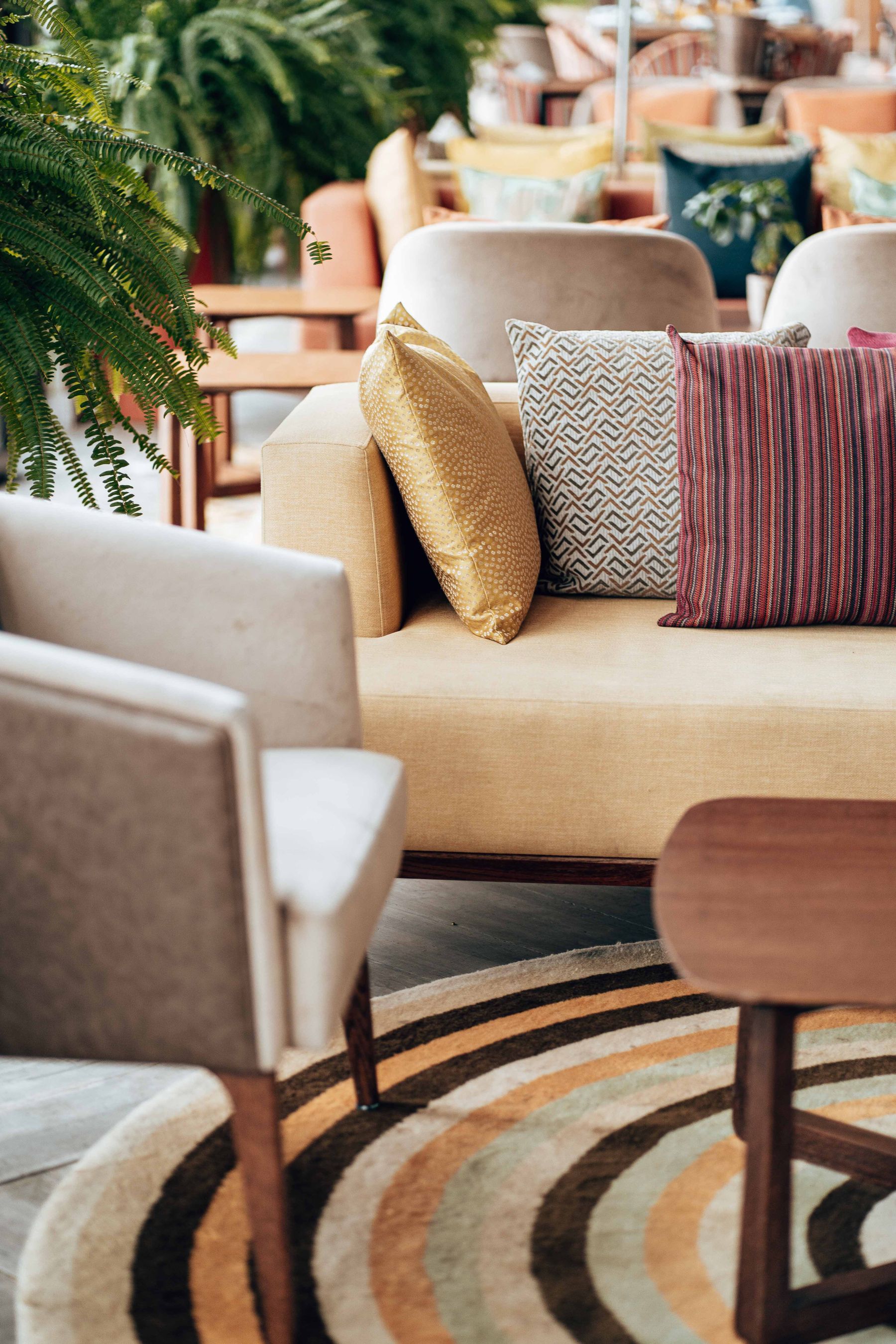 Curved patterned rug beneath a sofa, chair and wood table