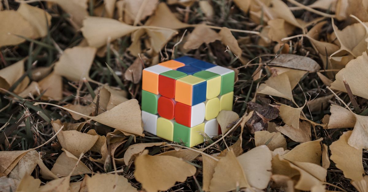 Cubie Rocks A Rubiks Cube on the Ground · Free Stock Photo