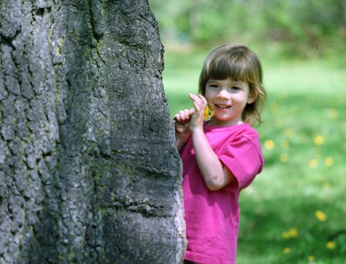 A Girl in Pink Shirt Standing Near the Rock Formation