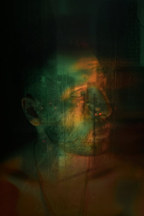 Green and Orange Lights on a Man