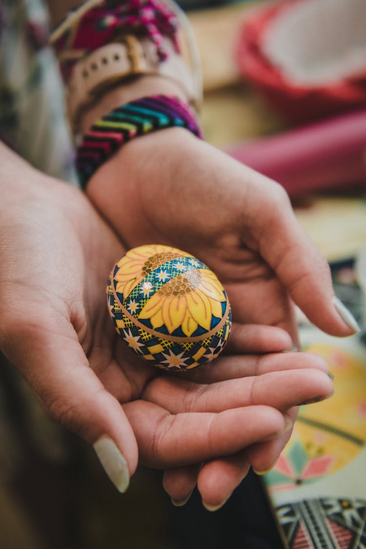 A Person Holding A Ukrainan Sunflower Pysanky Egg