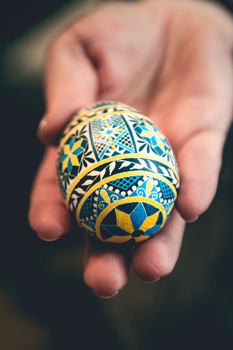 A Person Holding A Ukrainian Pysanky Egg