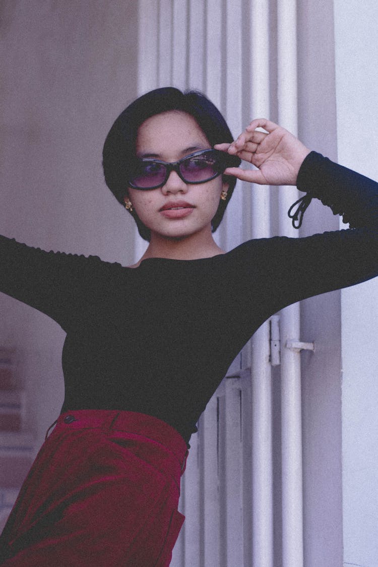 A Woman In Black Long Sleeve Shirt Wearing Black Sunglasses