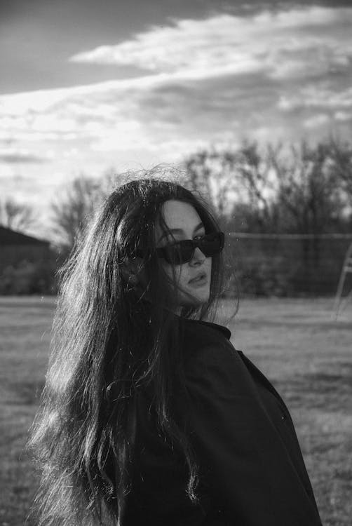 Grayscale Photo of Woman in Black Sunglasses and Black Jacket