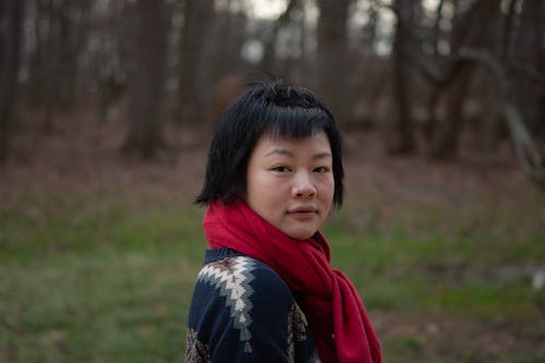 A Woman in Red Scarf Looking Over Shoulder