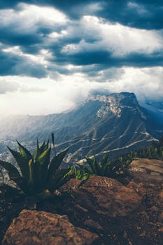 Dramatic landscape view with mountains and cloudy skies at Mirador Cuatro Palos in Querétaro.