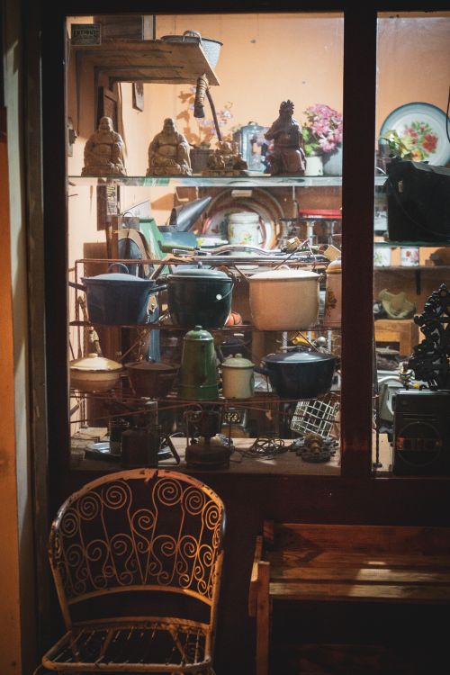 Free Cozy vintage shop window showcasing kitchenware and decor in Indonesia. Warm indoor setting. Stock Photo