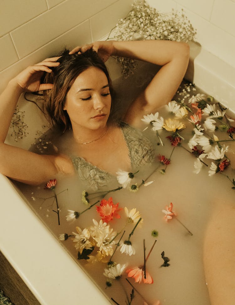 Woman Lying In A Bathtub With Flowers