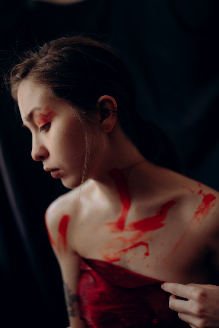 Portrait Of Woman With Red Paint Smudges On Her Body