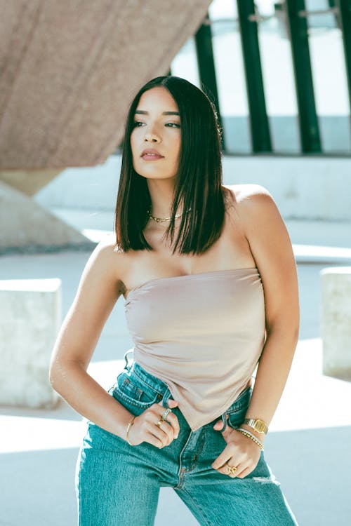 
A Woman Wearing a Tube Top and Denim Pants