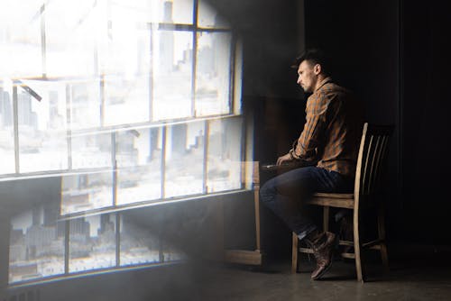 
A Man in a Plaid Shirt Playing the Piano