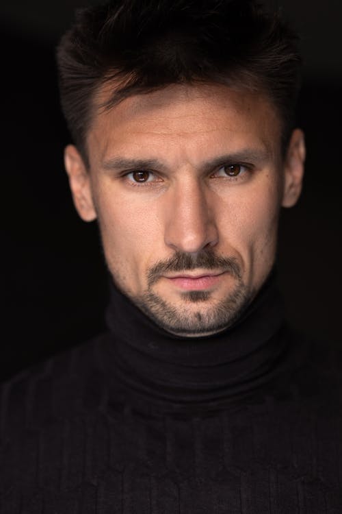 A Close-up Shot of a Man in Black Turtleneck Sweater